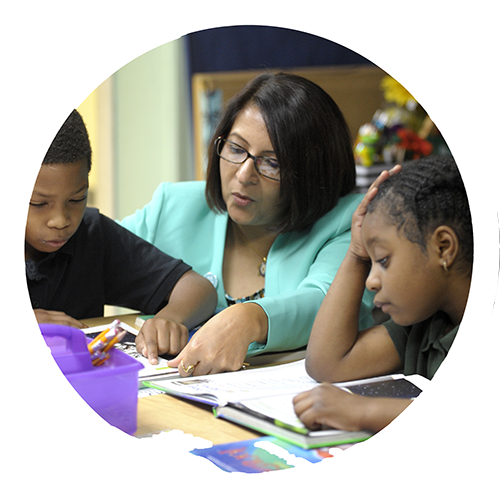 School principal working with students